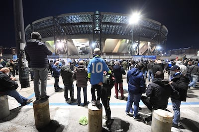 Napoli supporters stand outside the San Paolo stadium to pay tribute to Maradona. EPA