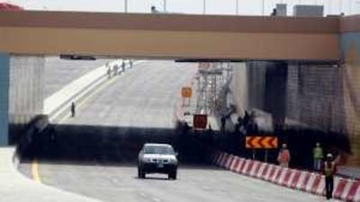 Workmen put the finishing touches to the first part of the Salam Street tunnel, which will open to traffic tomorrow, six months ahead of schedule.