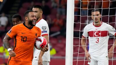 Memphis Depay of the Netherlands, left, celebrates scoring his side's fourth goal during the World Cup 2022 group G qualifying soccer match between the Netherlands and Turkey at the Johan Cruyff Arena in Amsterdam, Netherlands, Tuesday, Sept. 7, 2021. (AP Photo / Peter Dejong)