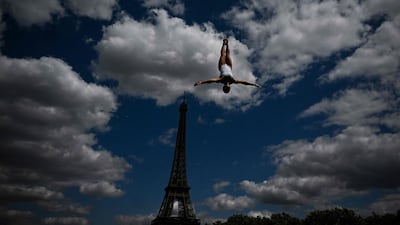 A diver during training for the Women's 20m Platform event at the European Aquatics Championships in Paris, with the Eiffel Tower in the background. AFP