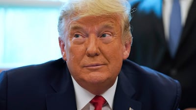 President Donald Trump listens while on a phone call with the leaders of Sudan and Israel, in the Oval Office of the White House. AP Photo