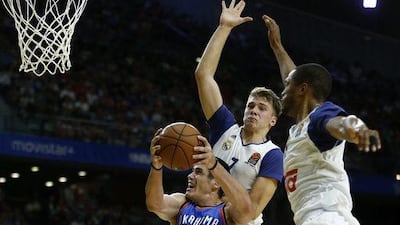 Oklahoma City Thunder forward Ersan Ilyasova, left, jumps to the basket against Real Madrid. Daniel Ochoa de Olza / AP