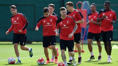 Liverpool's Alberto Moreno, centre, previously played at Sevilla and is a lifelong fan of the club. The two sides will meet in the Europa League final on May 18, 2016, with both silverware and a Uefa Champions League place up for grabs. AFP / PAUL ELLIS