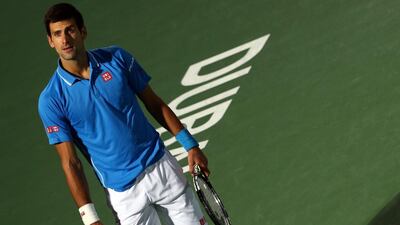 Djokovic reacts after losing a point to Federer. Marwan Naamani / AFP