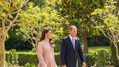 Britain's Prince William arrives with Catherine, Princess of Wales, who is wearing a blush-pink Elie Saab gown and carrying a gold clutch from Wilbur & Gussie