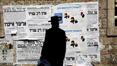 A Jewish ultraorthodox man looks onto a local billboard with instructions related to coronavirus in the Orthodox Jewish neighbourhood of Jerusalem on March 27, 2020. Reuters