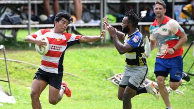 Lito Ramirez, left, has channelled his childhood struggles into becoming a national-level rugby player. Joshua Melvin / AFP