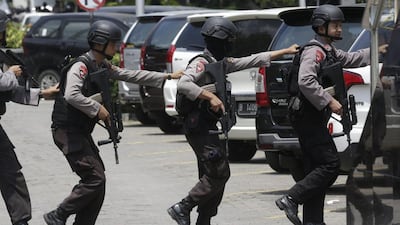 Police officers take their position near the site where an explosion went off in Jakarta. Dita Alangkara / AP Photo