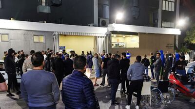 Men gather outside a hospital where some injured people are believed to be transferred to, after an explosion, near Sidon in southern Lebanon April 12, 2022. REUTERS/Ali Hankir NO RESALES. NO ARCHIVES.