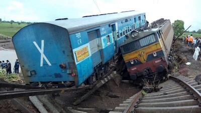 Sections of two passenger trains lie next to each other following a derailment after they were hit by flash floods on a bridge outside the town of Harda in India's Madhya Pradesh state on August 5, 2015. AFP