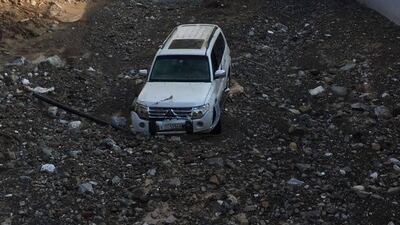 Five people were rescued from this car after it was swept away in a flood in Wadi Chees on Thursday. Courtesy Sharjah Police
