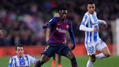 Ousmane Dembele, left, is tackled by Leaganes midfielder Mikel Vesga. AP Photo