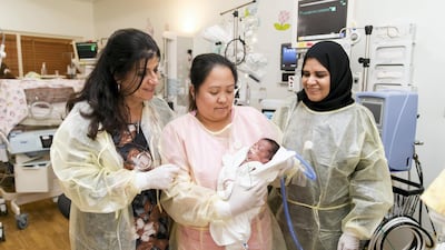 Dr Leanne Bricker, left, with colleagues at the Corniche Hospital. Abu Dhabi's largest maternity hospital delivers 6,000 babies a year. Reem Mohammed / The National