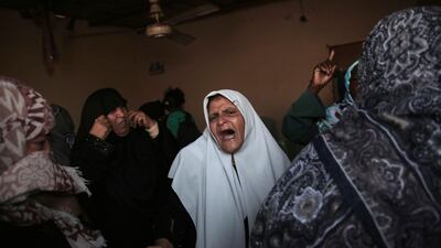 Relatives of 25-year-old Ahmed Arafa, who was shot and killed Tuesday by Israeli troops during the ongoing protest along the Gaza Strip border with Israel, mourn during his funeral in town of Deir el-Balah, central Gaza Strip, Wednesday, April 4, 2018. (AP Photo/Khalil Hamra)