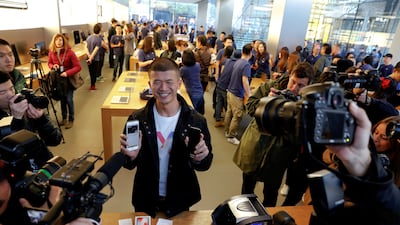 The first customer shows his new iPhone X after buying it at an Apple Store in Beijing, China. Damir Sagolj / Reuters