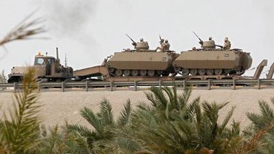 Armoured personnel carriers are transported on the flyover near the Bahrain-Saudi bridge in Manama today.