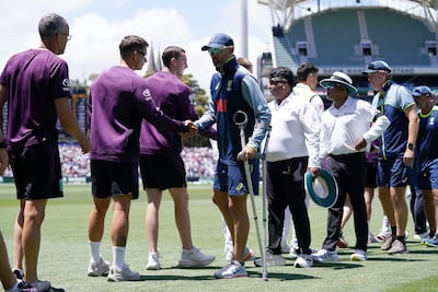 Australia's Nathan Lyon, centre, shakes hands with the England coaching staff following the conclusion of the third Ashes Test in Adelaide. PA