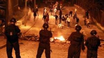 Palestinians throw stones at Israeli border police during clashes in East Jerusalem yesterday.
