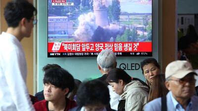 A TV screen shows file footage of the demolition of the 60-foot-tall cooling tower at its main reactor complex in Yongbyon, North Korea, in June. The North is set to dismantle its nuclear test site sometimes between Wednesday and and Friday. Ahn Young-joon / AP