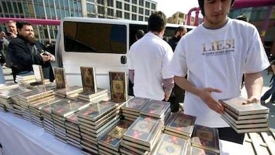 Free German-language copies of the Quran are given away at Potsdamer Platz in Berlin on Saturday.