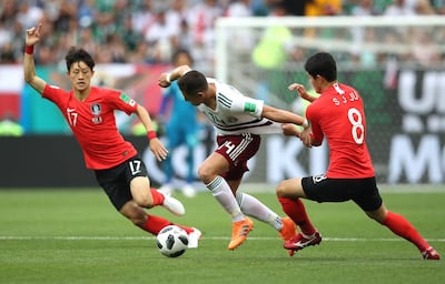 Javier Hernandez of Mexico, centre, is challenge by Ju Se-jong and Lee Jae-sung of South Korea. Clive Brunskill/Getty Images