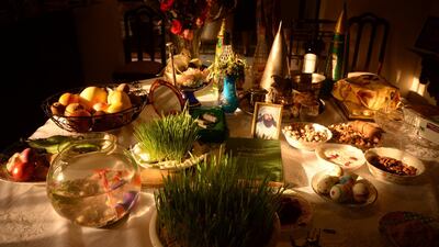 A table, referred to as 'Haft-Seen' prepared for the Nauroz feast, celebrated by Zoroastrians. These elements symbolise ideas such as rebirth (wheat, barley, lentil sprouts), love (dried Persian olives), beauty (apple) and patience that comes with old age (vinegar). Mobeen Ansari