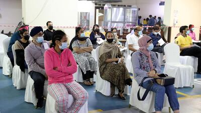 People wait to receive a shot of the Sinopharm vaccine at the temple.