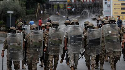 Lebanese army soldiers in riot gear arrive to the scene where supporters of Hezbollah and communist groups protest against US interference in Lebanon's affairs, near the American embassy, in Aukar north-east of Beirut, Lebanon. AP Photo