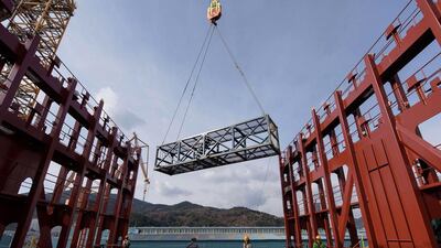A test container is lowered on to the deck of an under-construction Maersk triple-E class container ship at the Daewoo DSME shipyard in Okpo. Ed Jones / AFP