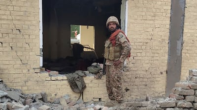 A soldier at the site of the suicide bombing that killed at least 26 security personnel in Dera Ismail Khan, Pakistan.