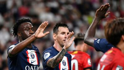 Arnaud Kalimuendo celebrates with Lionel Messi. AFP