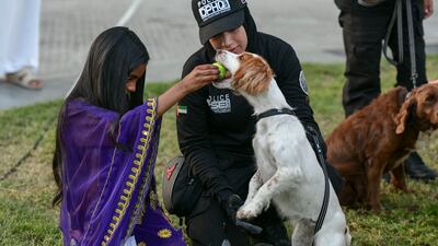 A library visitor and a police dog make friends at the event