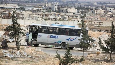 A bus carrying Jaish Al Islam rebel fighters and their families out of the Eastern Ghouta town of Douma arrives at the Wafideen crossing on April 14, 2018. AFP