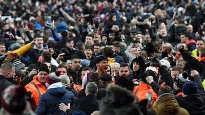 Aston Villa defender Tyrone Mings is mobbed by fans after their League Cup semi-final second-leg victory over Leicester City at Villa Park in Birmingham, on Tuesday, January 28. AFP
