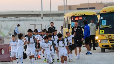 Real Madrid training session at the NYU Abu Dhabi football stadium. Young football fans arrive at the NYU Abu Dhabi staium to watch the Real Madrid training session.