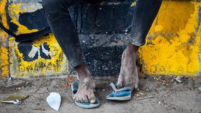 A migrant worker resting beside a street in Ghaziabad on the outskirts of New Delhi, May 20. Prakash Singh / AFP