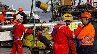 Personnel load tubes that will be used to extract the fuel from the wreck of the ship Costa Concordia, off the Tuscan coast in Italy.