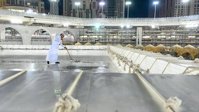 Teams clean the Kabaa in Makkah's Grand Mosque. HO