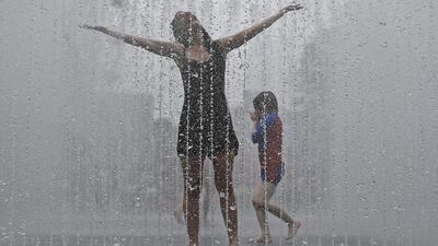 Thirty-year-old Maria, from Spain, enjoys the refreshment of the fountain in Southbank, London as Britain prepares for the hottest day in nine years on Wednesday. Frank Augstein/AP Photo