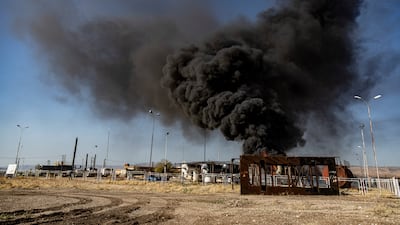 Smoke rises from an oil depot after a Turkish air strike near the town of Qamishli in north-east Syria. AP