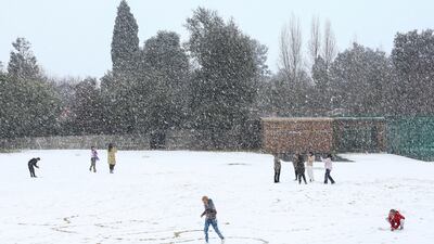 Children play in the snow at Laerskool Orion in Brackenhurst, a suburb south of Johannesburg, South Africa. Reuters