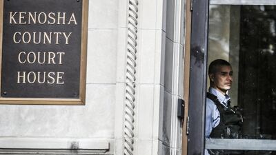 A law enforcement officer keeps watch at the the Kenosha County Courthouse as the jury deliberates for a third day. EPA