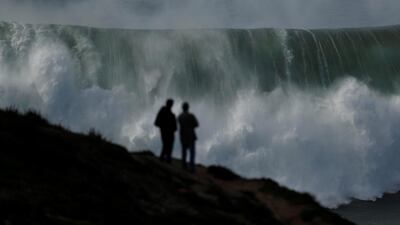 People gather to watch a tow-in surfing session at Praia do Norte in Nazare, Portugal. Rafael Marchante / Reuters