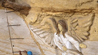 Polish artist Mario, sculptor of St. Simon the Tanner Monastery complex, climbs a ladder while working on a relief at the church in the Egyptian capital Cairo's eastern hillside Mokattam district. Mario spent more than two decades carving the rugged insides of the seven cave churches and chapels of the rock-hewn St. Simon Monastery and church complex atop Cairo's Mokattam hills, with designs inspired by biblical stories. It was all done to fulfil the wishes of the church's parish priest who met Mario in the early 1990s in Cairo. The Polish artist, who had arrived in Egypt earlier on an educational mission, was then looking for an opportunity to serve God at the monastery. AFP