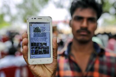 A man displays a phone showing a fake news story which had spread on WhatsApp. Bloomberg