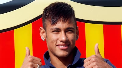 Neymar poses for photographs after completing his transfer from Santos to Barcelona in 2013. Reuters