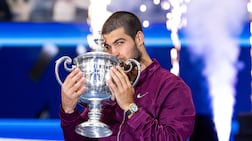 Carlos Alcaraz of Spain returns to defend his men's singles title. Imagn Images