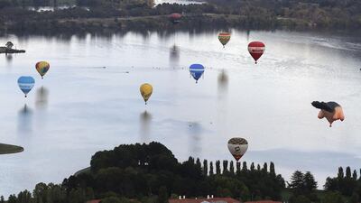 Hot air balloons float over Lake Burley Griffin during the Balloon Spectacular in Canberra, Australia. (Rob Griffith / AP Photo / March 8, 2014)