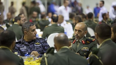 Major General Mohamed Khalfan Al Romaithi, Head of the Security, Justice, Health and Safety Committee of Abu Dhabi Executive Council and Deputy Commander General of Abu Dhabi Police, back left, and Major General Pilot Sheikh Ahmed bin Tahnoon bin Mohammed Al Nahyan, Chairman of the National and Reserve Service Authority, back right, at an iftar after attending the officers’ graduation ceremony.