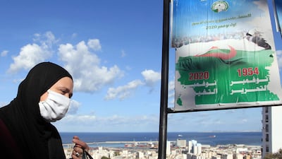 A woman walks past posters promoting the vote for the upcoming referendum, Tuesday. AP